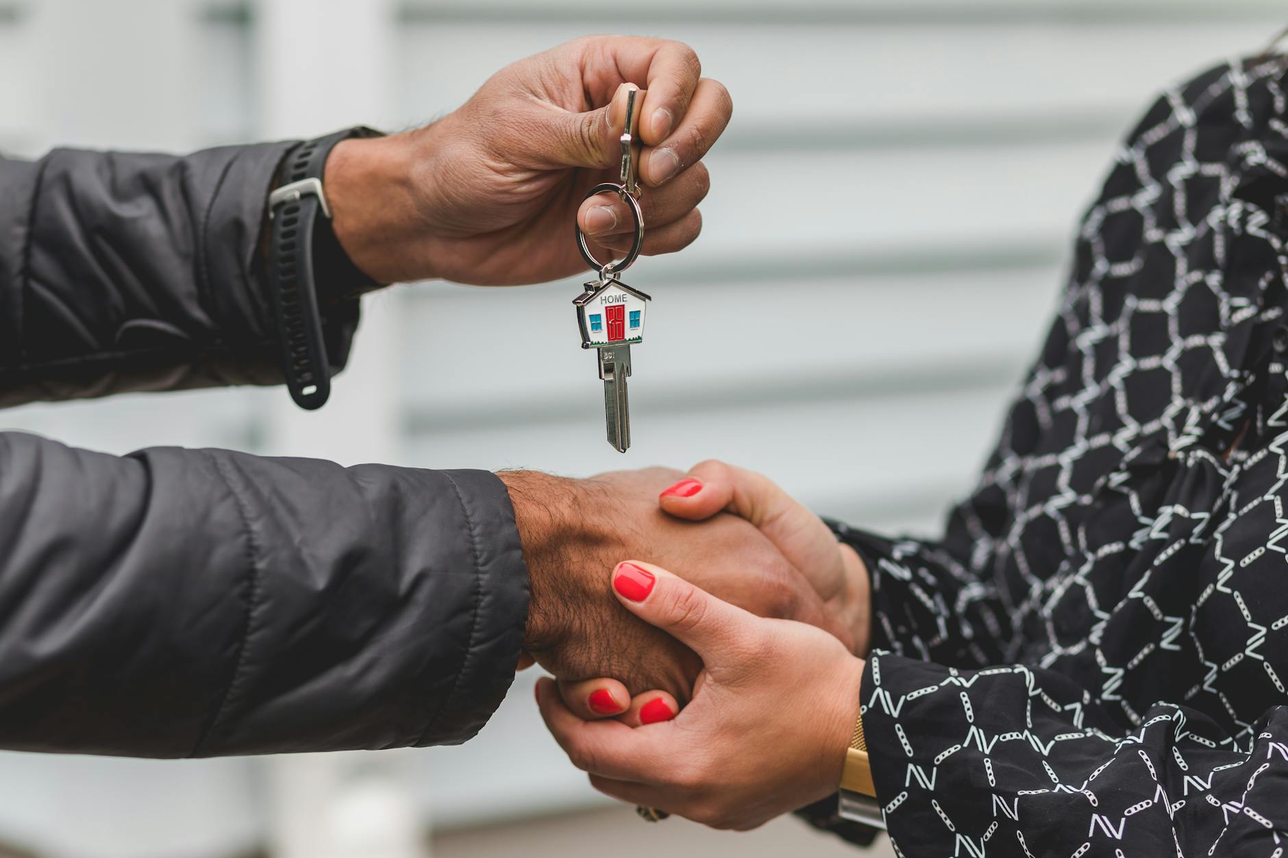 person holding silver key